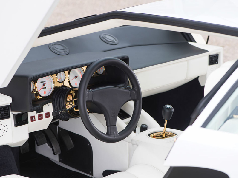 Illustration for article titled I Am Morally Offended By This Gold-Plated Lamborghini Countach Interior